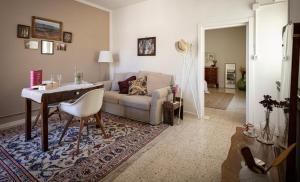 a living room with a couch and a table at App. con terrazza panoramica in centro-Montefalco in Montefalco +28 photos