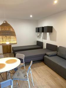 a living room with a couch and a table at Pokoje blisko morza in Sarbinowo