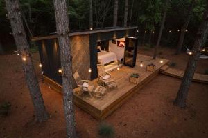 an overhead view of a cabin in the woods at Glamping cabin with private deck and hot tub! in Guntersville +8 photos
