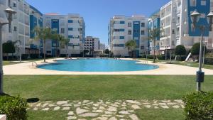 a large swimming pool in the middle of a building at martil in Martil