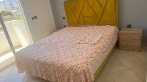 a bedroom with a bed with a wooden headboard at martil in Martil