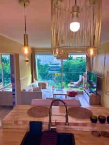 a kitchen with a sink and a living room at Magnifique appartement avec une très belle vue in Marseille