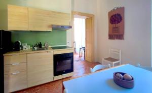a kitchen with wooden cabinets and a blue counter top at Camelia Riviera D'Orta in Gozzano