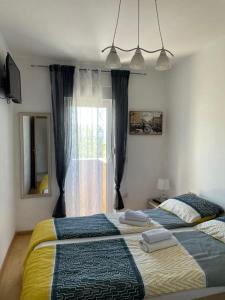 Ένα ή περισσότερα κρεβάτια σε δωμάτιο στο Apartman Mia