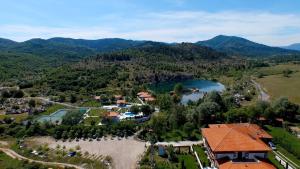 an aerial view of a resort with a lake and mountains at Комплекс Белите скали in Gaytaninovo