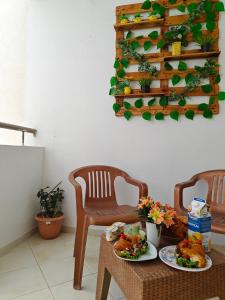 two chairs and a table with food on it at Appartement slim centre sousse in Sousse +6 photos