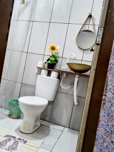 a bathroom with a toilet and a sink at Suíte estrela do sal in Salinópolis