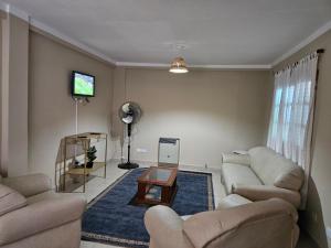 een woonkamer met twee banken en een tv bij La Loma in Salta