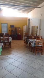 a dining room with tables and chairs and a refrigerator at Hotel Arbom in Mogi Guaçu +15 photos