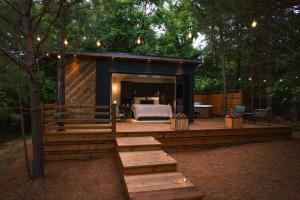 a large wooden deck with a bed in a room at Luxury tiny house with hot tub and private deck! in Guntersville