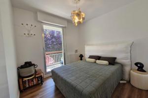a bedroom with a large bed and a window at Family apartment near the sea of Houlgate in Houlgate