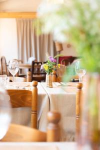 a table with glasses and flowers on top of it at Hôtel du Grand Capelet in Belvédère