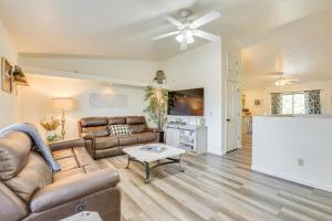 a living room with a couch and a table at Hike and Golf Family Home with Deck in Payson! in Payson