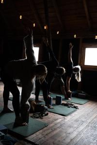 a group of people doing yoga in a room at Drømmebrygga in Averoy
