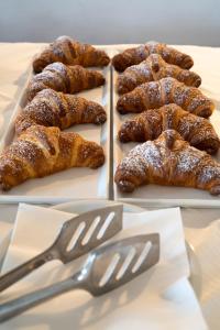 a table with three plates of pastries and a pair of forks at Park Hotel Cilento in Marina di Camerota