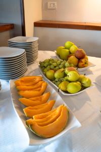 two plates of fruit on top of a table at Park Hotel Cilento in Marina di Camerota