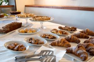 a table with various pastries and desserts on plates at Park Hotel Cilento in Marina di Camerota