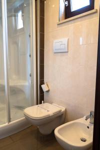 a bathroom with a toilet and a shower and a sink at Park Hotel Cilento in Marina di Camerota