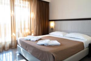 a bedroom with a large bed with towels on it at Park Hotel Cilento in Marina di Camerota