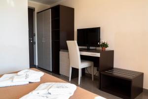 a bedroom with a desk with a computer and a television at Park Hotel Cilento in Marina di Camerota