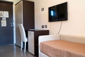 a hotel room with a bed and a flat screen tv at Park Hotel Cilento in Marina di Camerota