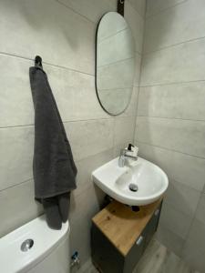 a bathroom with a sink and a mirror at Santa Banana Apartment Alicante in Alicante +9 photos