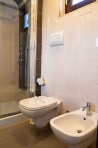 a bathroom with a toilet and a sink and a shower at Park Hotel Cilento in Marina di Camerota