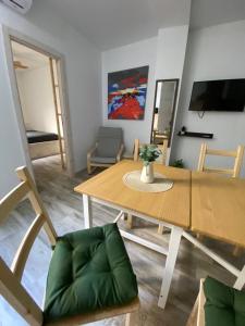 a dining room with a wooden table and chairs at Santa Banana Apartment Alicante in Alicante