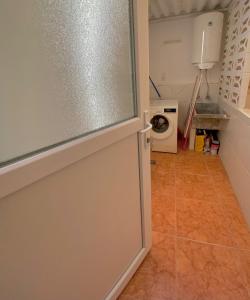 a kitchen with a door to a laundry room at Corazón de Santa Pola in Santa Pola +11 photos