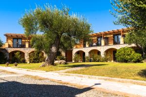 a building with a tree in front of it at Park Hotel Cilento in Marina di Camerota