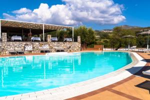 a large swimming pool with blue water at Park Hotel Cilento in Marina di Camerota