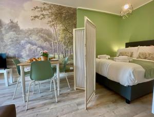 a bedroom with a bed and a table and chairs at Happy Family Apartments Maggiolino in Genova
