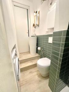a bathroom with a toilet and a sink at Happy Family Apartments Maggiolino in Genova