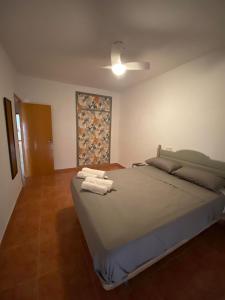 a bedroom with a large bed with towels on it at Corazón de Santa Pola in Santa Pola
