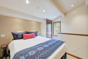 a bedroom with a large bed with blue and red pillows at Lodge at Lionshead 310 in Vail