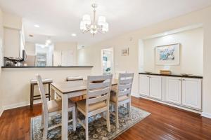 a kitchen and dining room with a wooden table and chairs at 17C Fairway 17 Waterside at True Blue condo by Peace Vacations in Pawleys Island