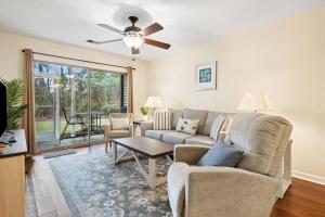 a living room with a couch and a table at 17C Fairway 17 Waterside at True Blue condo by Peace Vacations in Pawleys Island