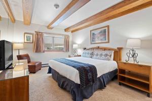 a hotel room with a bed and a television at Lodge at Lionshead 270 in Vail +13 photos