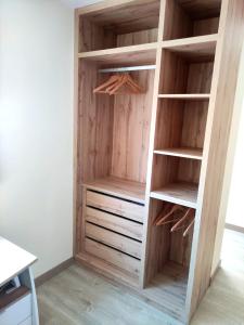 a built in closet with wooden shelves and drawers at Apartamento acogedor en Valencia Centro perfecta ubicación in Valencia