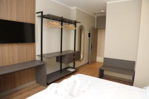 a bedroom with a bed and a television in a room at Kruja Luxury Suites in Krujë
