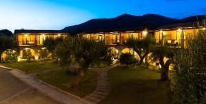 a building with trees in front of it at night at Park Hotel Cilento in Marina di Camerota