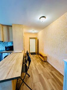 a kitchen with a table and chairs in a room at Rožu namu apartamenti 2 in Kuldīga
