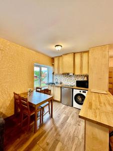 a kitchen with a table and chairs in a room at Rožu namu apartamenti 2 in Kuldīga