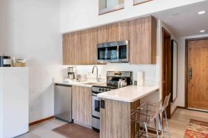 a kitchen with a sink and a stove top oven at Lodge at Lionshead 320 in Vail