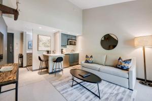 a living room with a couch and a table at Lodge at Lionshead 330 in Vail