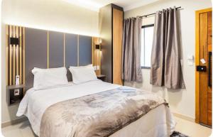 a bedroom with a large bed and a window at Sis in Sao Paulo