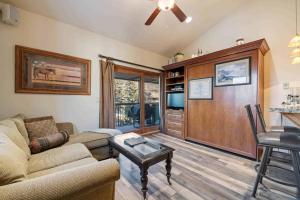 a living room with a couch and a table at Lodge at Lionshead 340 in Vail