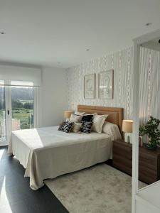 a bedroom with a large bed with pillows on it at Casa Manolo de Amparo in Vimianzo +22 photos