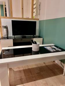 a living room with a table with a tv at « Le City » proche aéroport CDG, Parc Astérix, Disney, in Dammartin-en-Goële