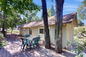 a cabin with a table and chairs on a deck at Walk to Town! Dog-Friendly Quincy Getaway w/ Deck in Quincy